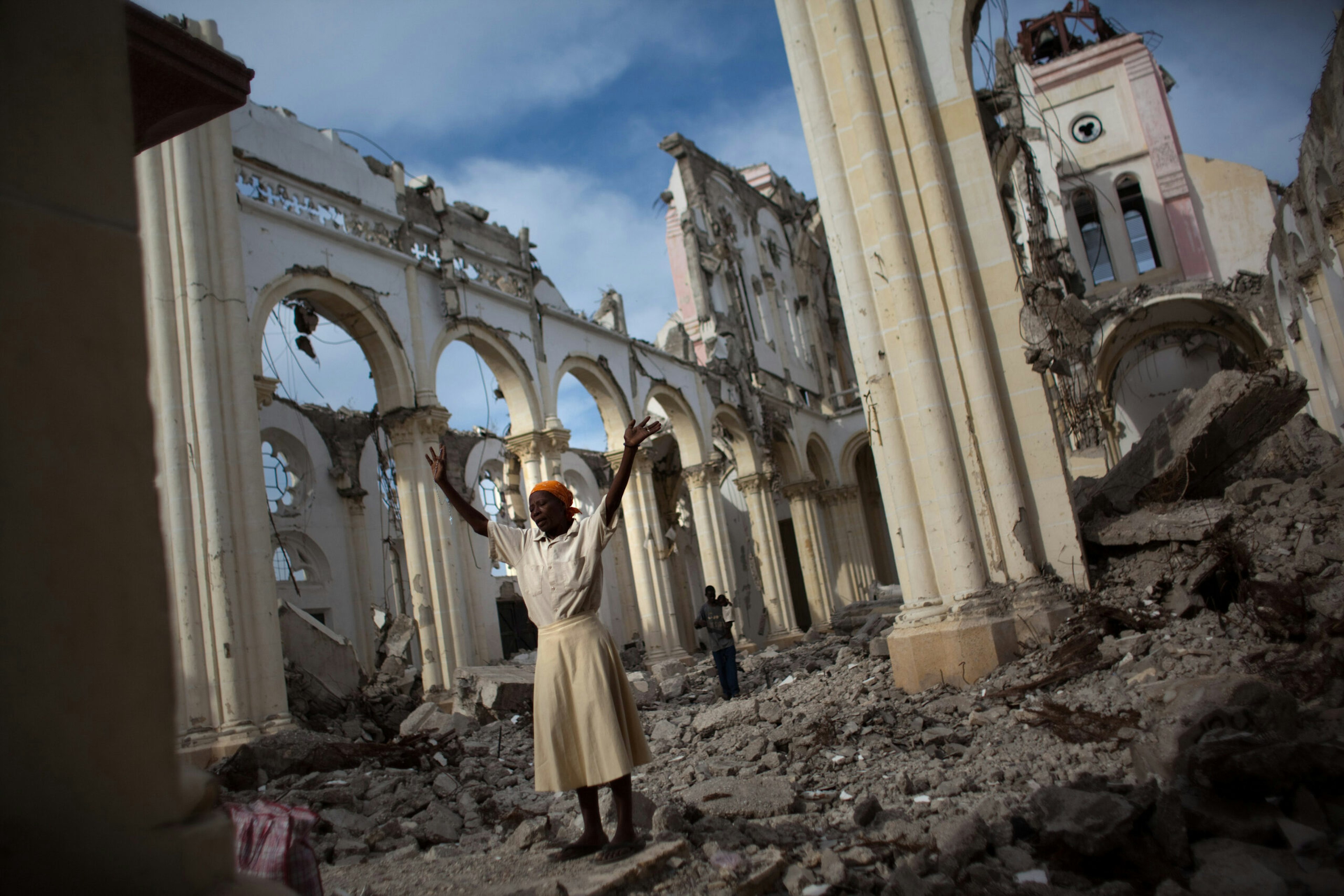 A woman prays in the earthquake wreckage of the main cathedral in Port-au-Prince, Haiti.