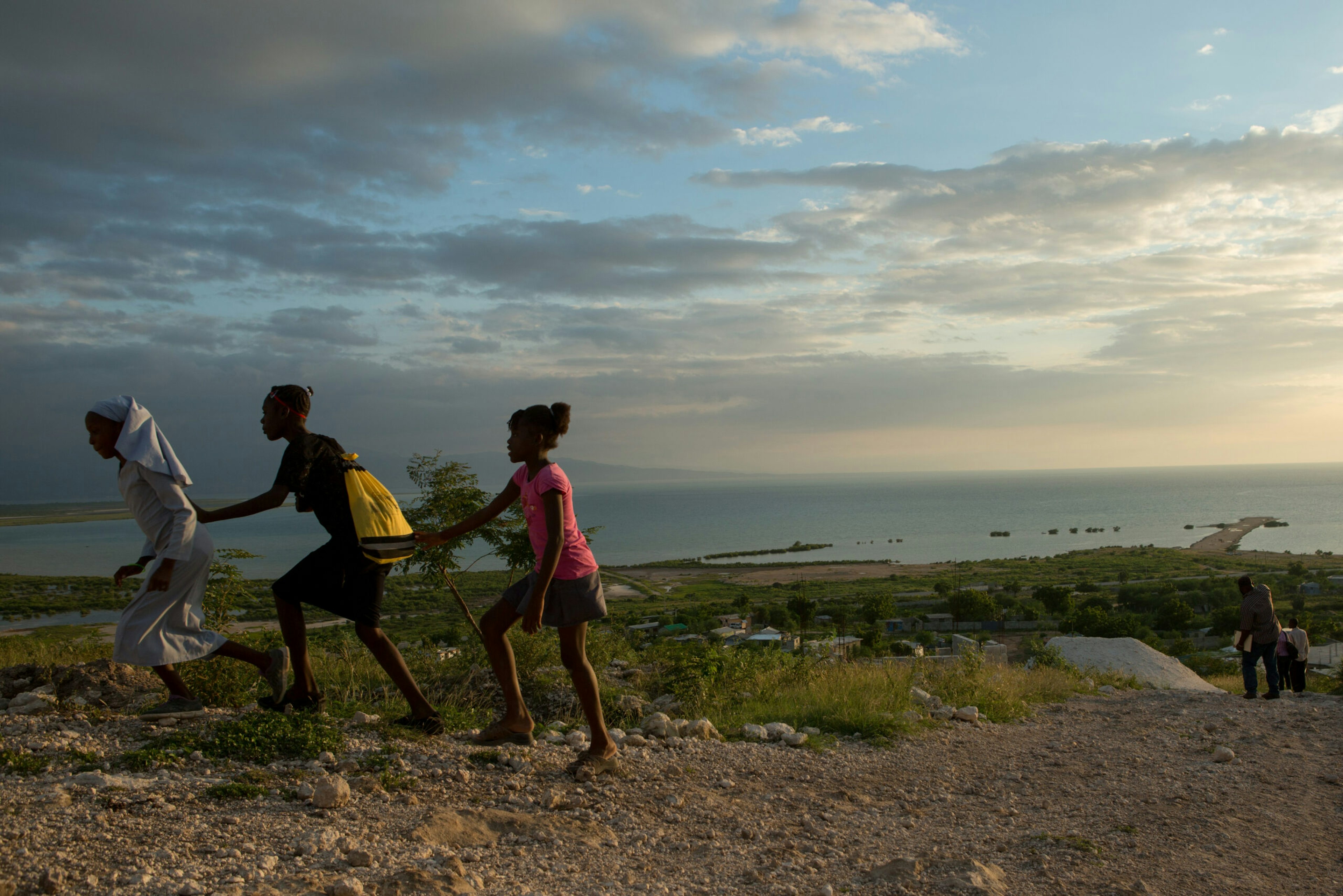 Left to right: Jean Naika, 12, Renan Emida, 15, and Sinilien Batechinda, 9, hang out after practicing a dance routine at the Frere Juldort School, which doubles as L’Eglise de Dieu de Philadelphie, May 13, 2016.