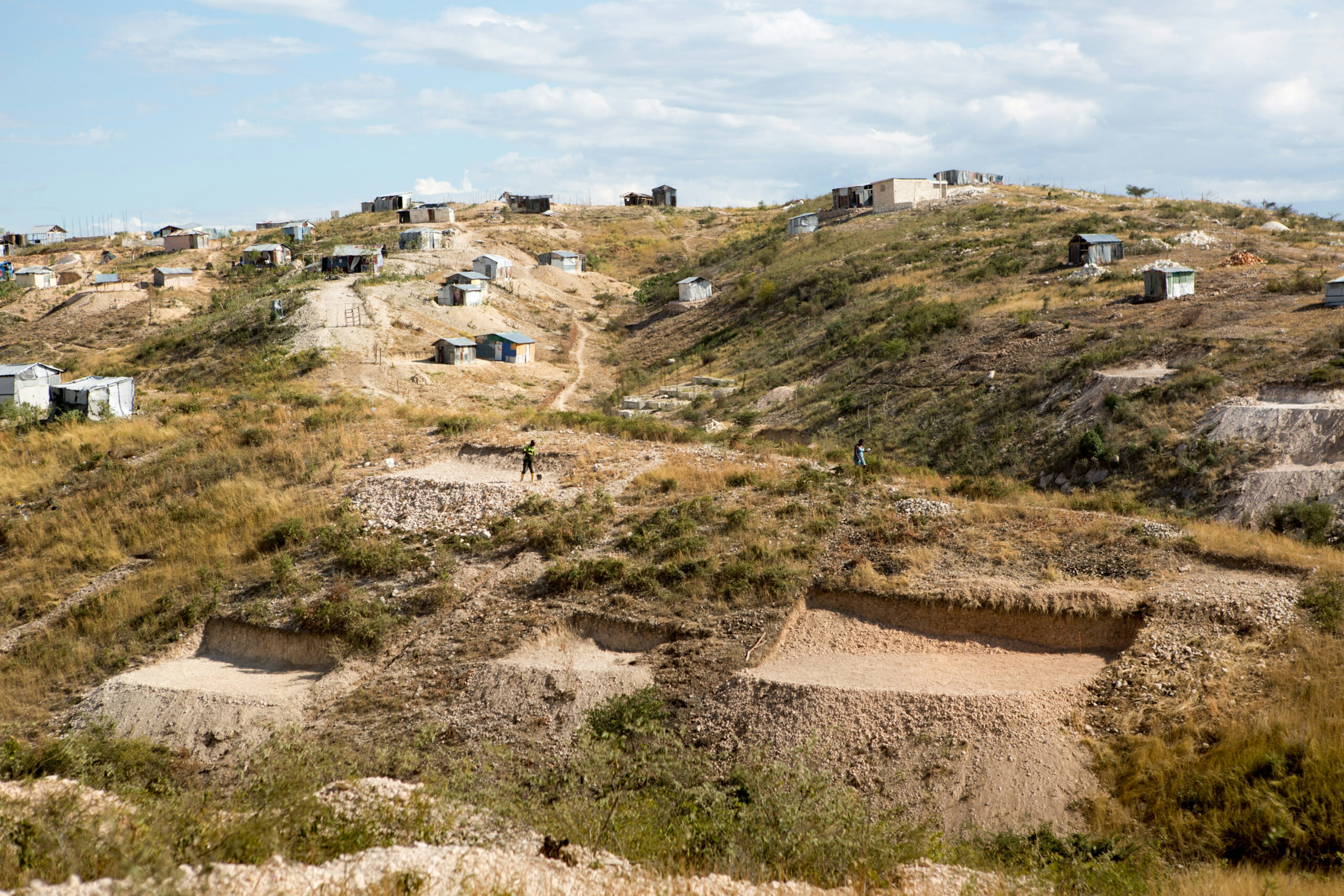 A man works to level a plot of land in order to begin building a home in the Canaan settlement just outside Port-au-Prince, Haiti, Jan. 10, 2015.