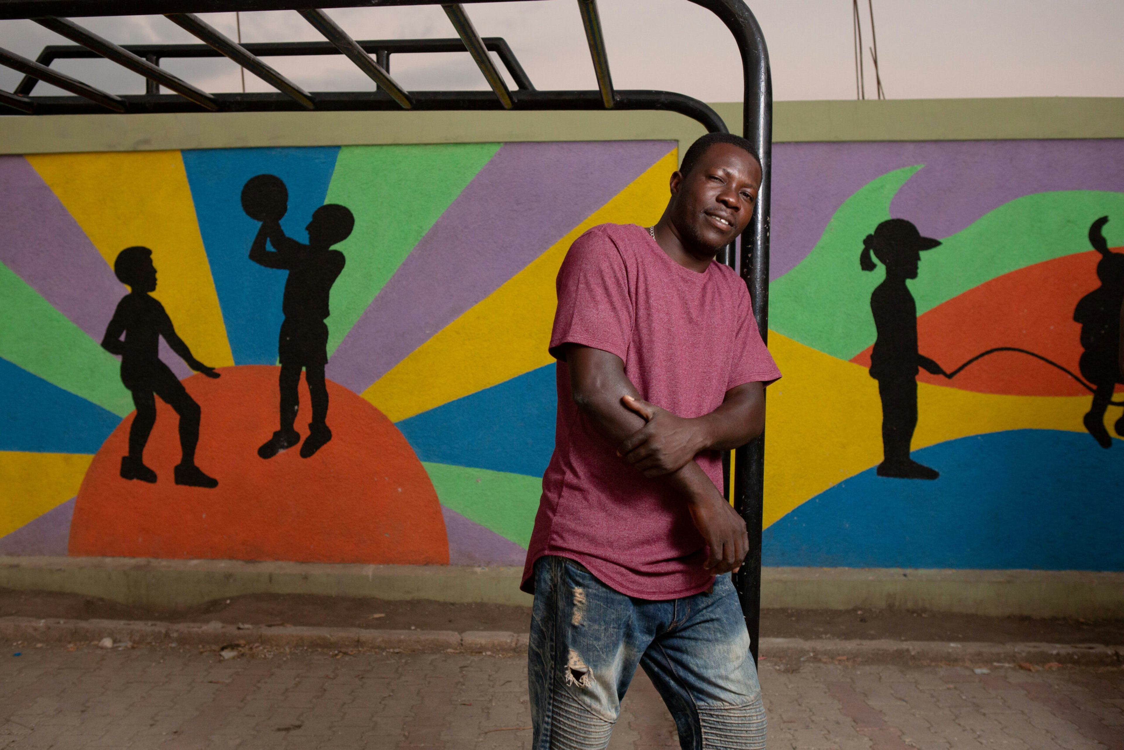 Community leader Evenson Louis poses for a photo in the recently completed public plaza in the Canaan 1 neighborhood of the Canaan settlement outside Port-au-Prince, Haiti, Jan. 6, 2019.