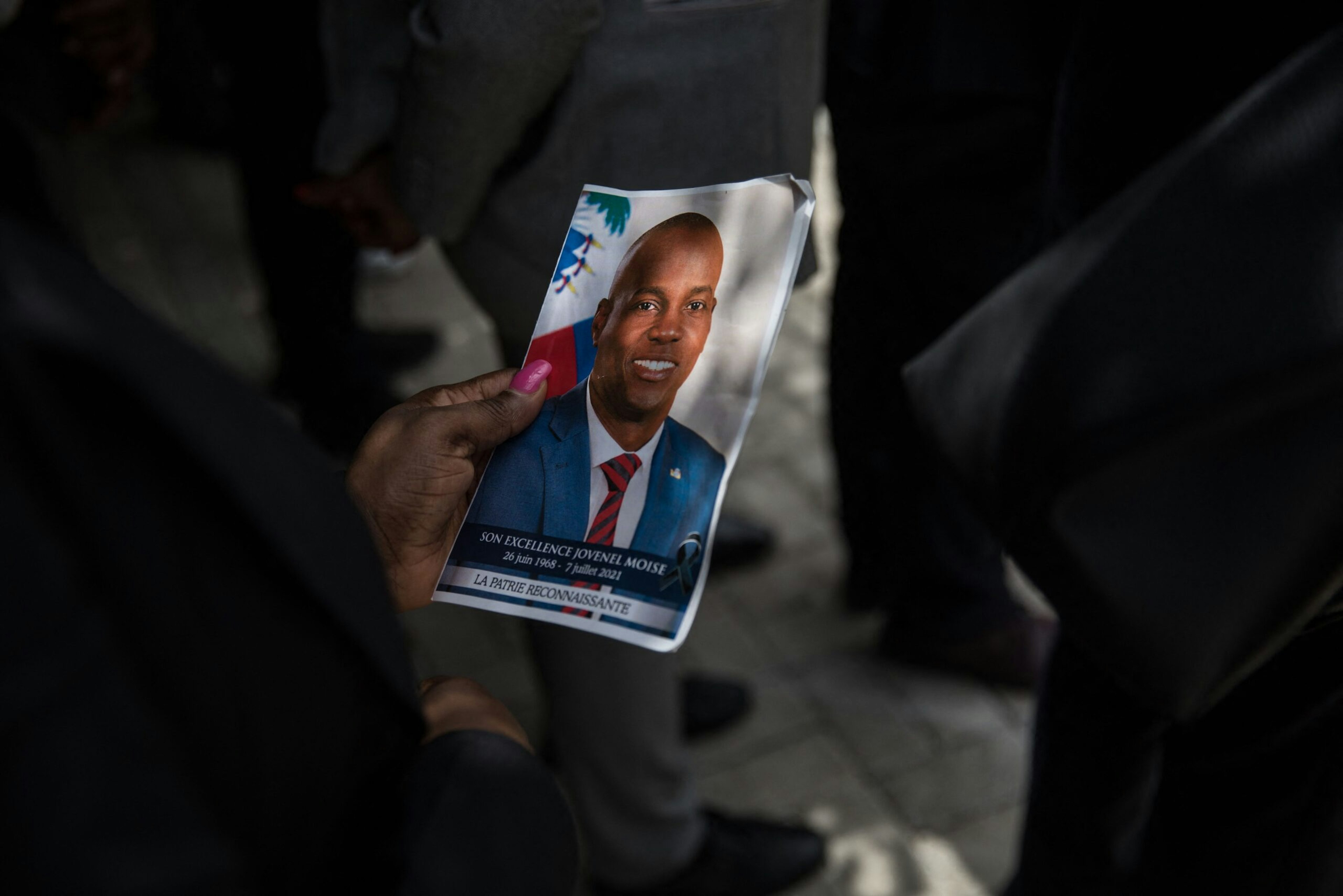 A guest holds a picture of late Haitian President Jovenel Moïse during a ceremony at the National Pantheon Museum in Port-au-Prince, July 20, 2021.