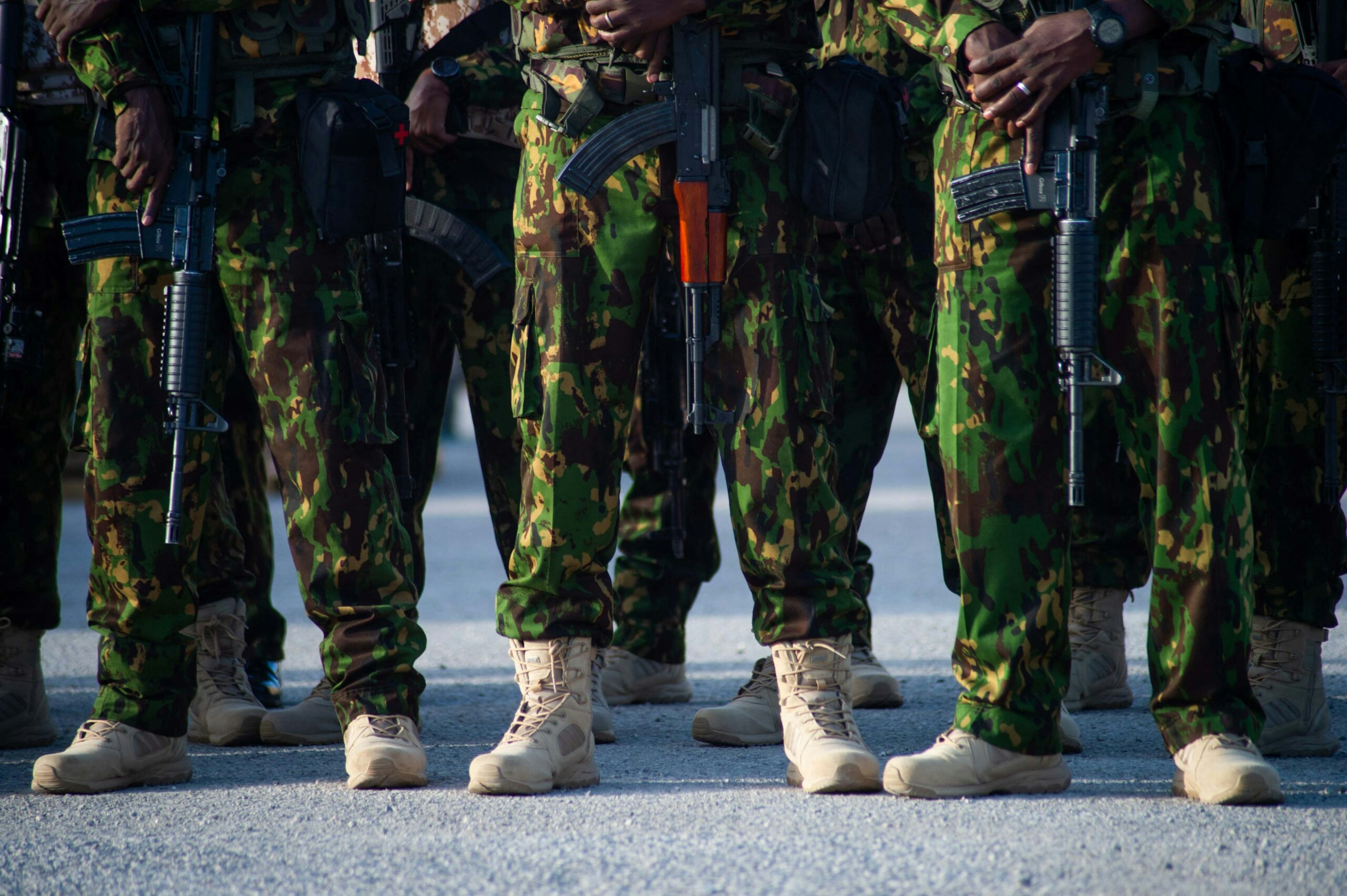 Kenyan police officers stand at attention during a visit by Haitian government officials, including acting Prime Minister Garry Conille, to their base in the Clercine neighborhood of Port-au-Prince, Haiti, June 26, 2024.