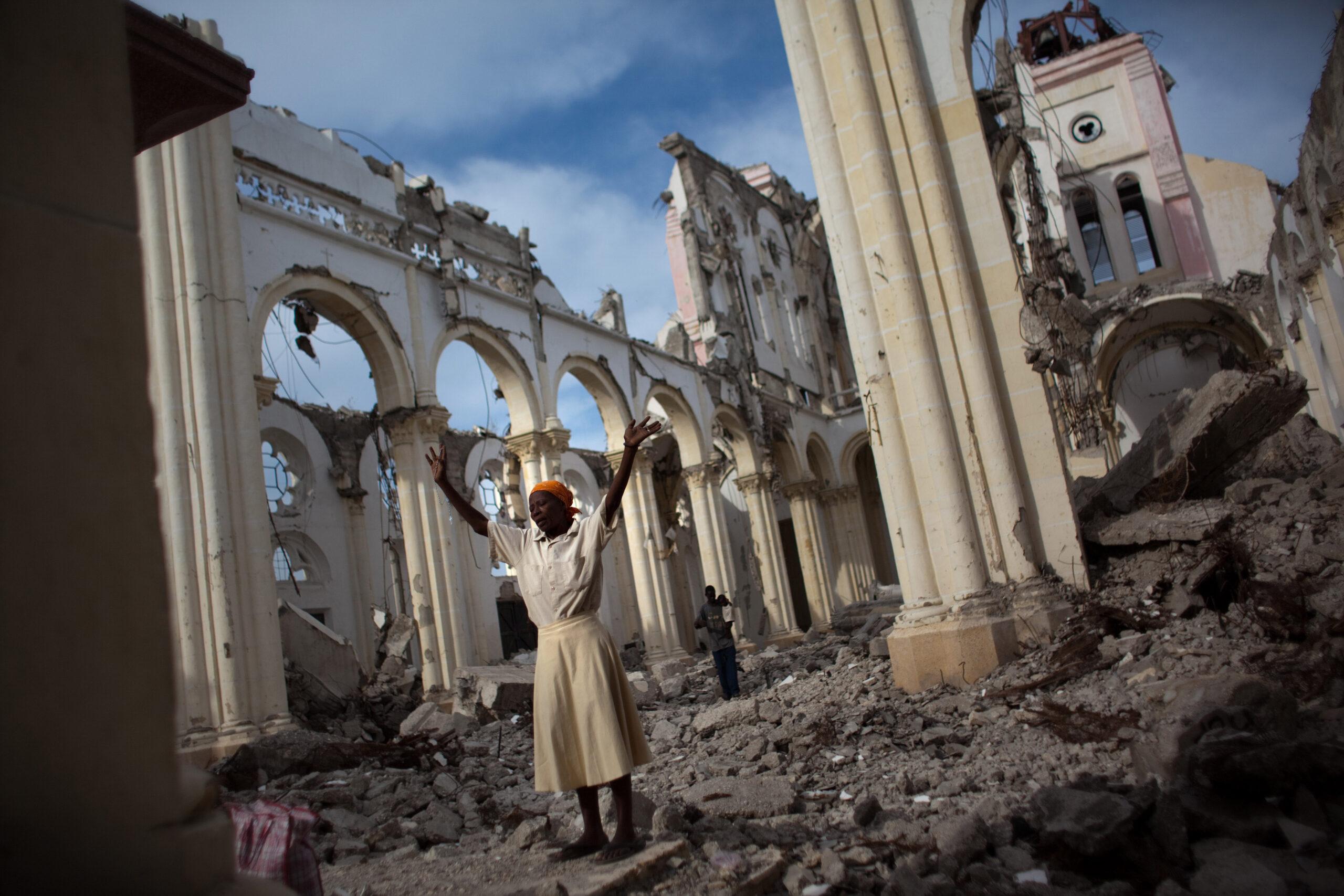 A woman prays in the earthquake wreckage of the main cathedral in Port-au-Prince, Haiti.